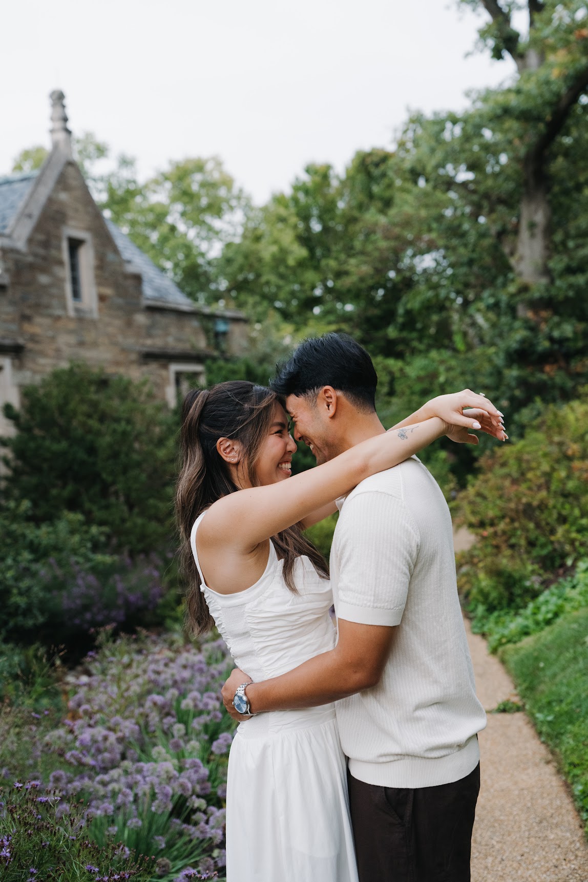 Andy and Jina embracing in a garden
